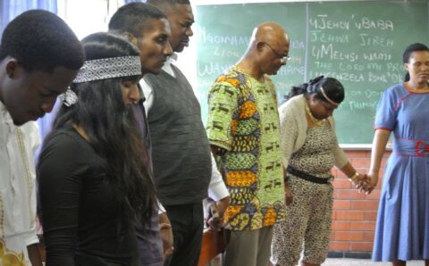 Dr Thomas praying @ African Day