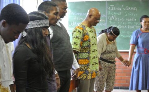 Dr Thomas praying @ African Day